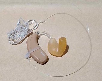 Clip trasparente Apparecchio acustico con clip di ritenzione invisibile e impianto cocleare