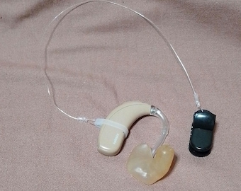 black clip Single invisible retention clip hearing aid and cochlear implant
