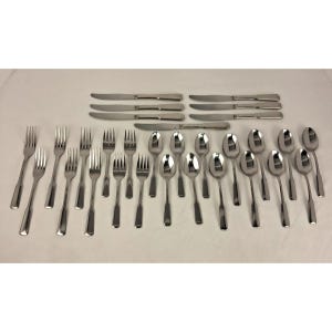 May include: A complete stainless steel flatware set, including forks, knives, and spoons. The silverware is arranged on a white surface, showcasing a polished, reflective finish. The set includes various sizes of forks, knives, and spoons, suitable for a formal dining setting.