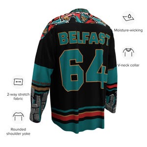 May include: Black hockey jersey with teal and gold accents. The jersey has the text "BELFAST" and the number "64" on the back. The jersey has a V-neck collar and a rounded shoulder yoke.