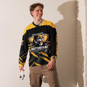 May include: Black and yellow long-sleeved jersey with a black panther graphic and the text "Nottingham Panthers" on the front. The jersey has a yellow and black striped pattern on the sleeves.