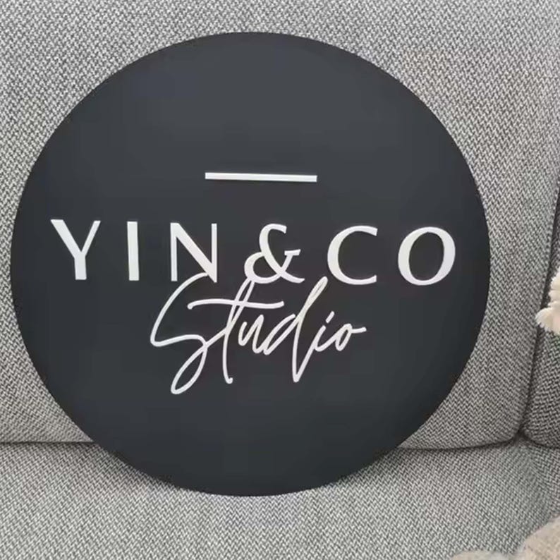 May include: A black circular sign with white text that reads "YIN & CO Studio" in a cursive font.