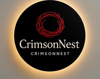 May include: A circular black wall sign featuring a red abstract nest graphic above the white text CrimsonNest and the capitalized text CRIMSONNEST. The sign is backlit, creating a soft glowing halo effect around its perimeter.