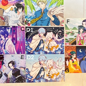 May include: A selection of anime-style art prints, each depicting characters in colourful scenes. The prints feature couples, individuals, and fantasy landscapes with detailed illustrations and vibrant colour palettes.