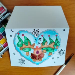 Carte de voeux Noël cœur renne chantant à l'aquarelle