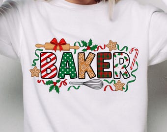 May include: White sweatshirt with a colorful "BAKER" graphic. The word "BAKER" is designed with various patterns, including red and white stripes, green polka dots, and a plaid pattern. The design includes a rolling pin, whisk, gingerbread cookies, and holly.
