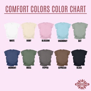 May include: A color chart displaying Comfort Colors t-shirts in various shades. The image showcases ten different colors, including white, ivory, blossom, chambray, bay, midnight, moss, pepper, espresso, and black. The text "COMFORT COLORS COLOR CHART" is at the top.