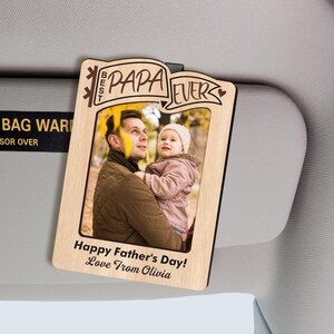 May include: A wooden photo frame with the words "Best Papa Ever" and a photo of a man holding a child. The frame also has the text "Happy Father's Day! Love From Olivia."