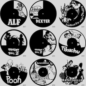 May include: A collection of black vinyl record art featuring various cartoon characters. Designs include ALF, Dexter, Asterix and Obelix, Dragon Ball Z, Pikachu, Winnie the Pooh, and Ratatouille. Each piece has a central hole.