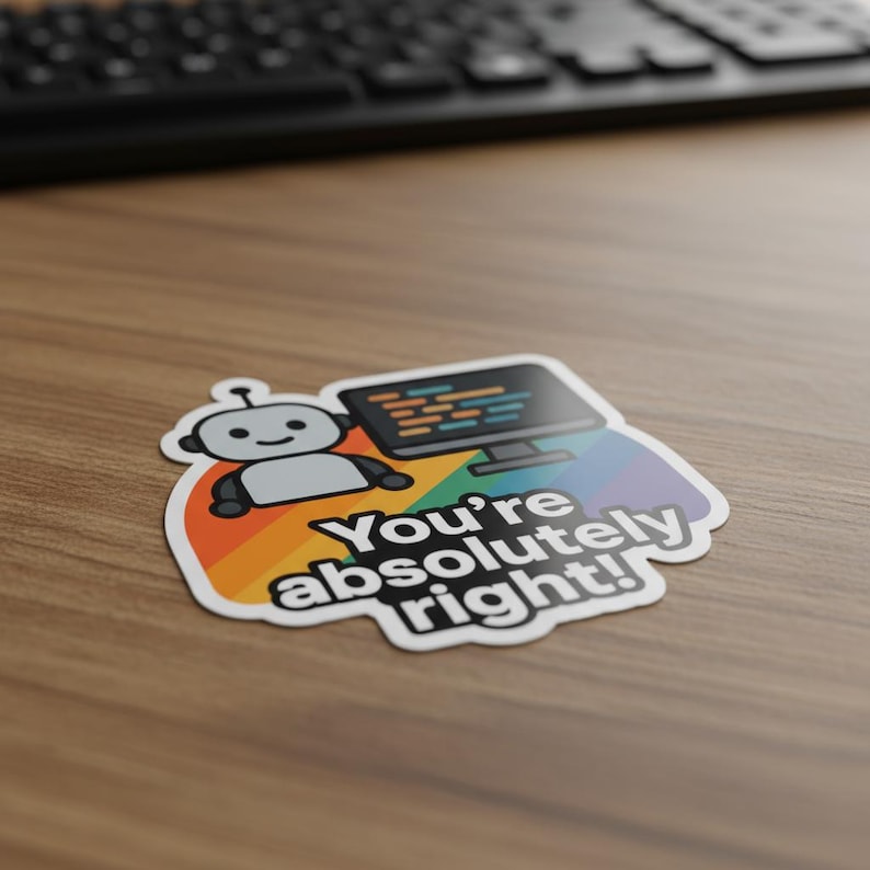 Puede incluir: Una pegatina con un robot de dibujos animados y un monitor de ordenador con c&oacute;digo, sobre un fondo de arco&iacute;ris. El texto "You're absolutely right!" es blanco. Un teclado negro es visible en el fondo.