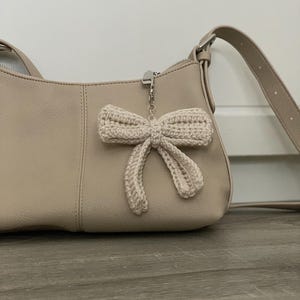 May include: A white ceramic mug with a black handle and the text "But First, Coffee" in a black, handwritten-style font. The mug is on a white surface.