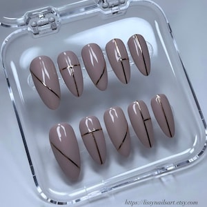 Custom nail sets with party-ready designs, gold designs, almond-style nails, nail art, handmade nails