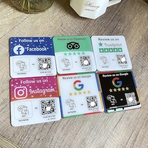 May include: Six colourful square cards with rounded corners. Each card has a different social media logo and text that says "Follow us on" or "Review us on". Each card has a QR code and an NFC symbol with the text "Tap Phone".