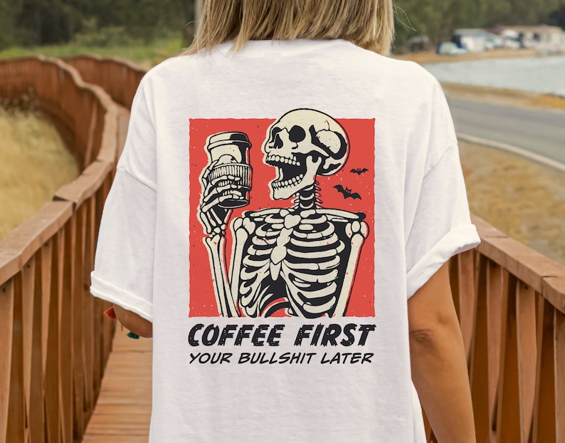 SVG PNG illustration of a skeleton holding a coffee cup with the humorous text Coffee first, Your bullshit later, designed in a playful style to celebrate Halloween. This quirky design combines a love for coffee with a cheeky message.
