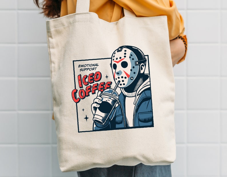SVGPNG illustration of the famous horror character drinking iced coffee through his mask, labeled with the text Emotional Support Iced Coffee. This Quirky and humorous design blends the iconic Halloween horror with coffee culture