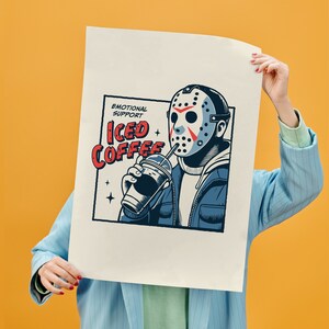 SVGPNG illustration of the famous horror character drinking iced coffee through his mask, labeled with the text Emotional Support Iced Coffee. This Quirky and humorous design blends the iconic Halloween horror with coffee culture