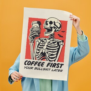 SVG PNG illustration of a skeleton holding a coffee cup with the humorous text Coffee first, Your bullshit later, designed in a playful style to celebrate Halloween. This quirky design combines a love for coffee with a cheeky message.