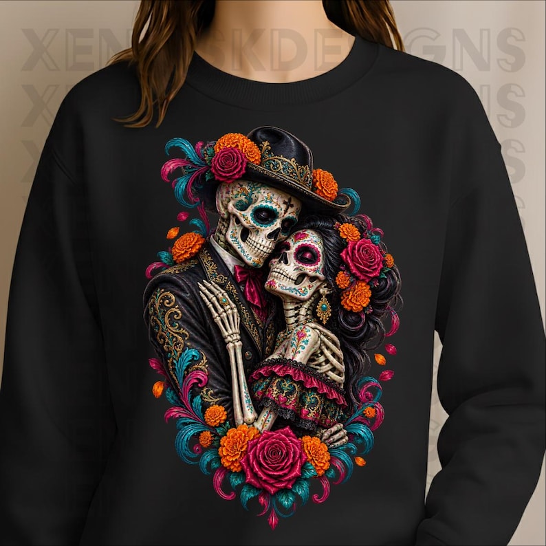 May include: A black crewneck sweatshirt featuring a vibrant graphic of two skeletons embracing. The skeletons are dressed in formal attire with intricate floral patterns, colourful marigolds, and roses in shades of red, orange, and teal.
