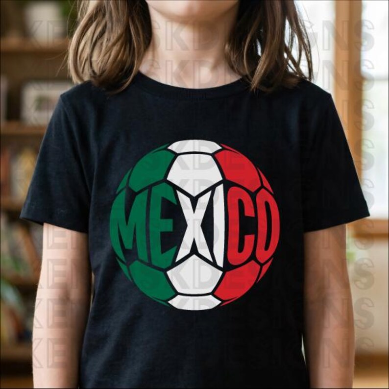 May include: A black short-sleeved t-shirt featuring a large circular graphic on the chest. The graphic is a soccer ball design colored with the green, white, and red stripes of the Mexican flag, with the word MEXICO printed in bold black letters.