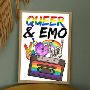 May include: A framed print with the words "QUEER & EMO" in rainbow and black lettering. The image includes a cassette tape, peace sign, heart, rainbow, and a hand making a rock and roll gesture.