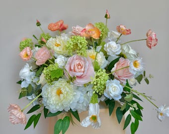 May include: A large bouquet of artificial flowers in shades of pink, white, and green. The bouquet includes roses, peonies, and other flowers.