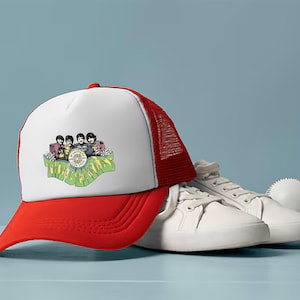 May include: A red and white trucker hat with a Beatles logo featuring the band members and the words "The Beatles". The hat is sitting on a white surface next to a pair of white sneakers.