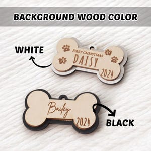 May include: Two bone-shaped pet ornaments. One is light wood with white trim, the name "Daisy", the text "First Christmas", and the year "2024". The other is light wood with black trim, the name "Bailey", and the year "2024".
