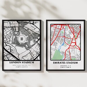 May include: Two black framed prints of maps of London Stadium and Emirates Stadium. The maps are in black and white with red highlights. The stadium names and team names are printed below the maps.