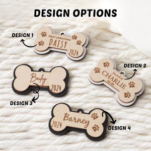 May include: Four dog bone-shaped pet tags with different designs. The tags are made of light wood with dark edges and feature names, dates, and paw prints. The text "DESIGN OPTIONS" is at the top. The tags are labeled Design 1, Design 2, Design 3, and Design 4.