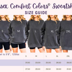 May include: A size guide for Unisex Comfort Colors sweatshirts. The image shows five models wearing gray sweatshirts in sizes S, M, L, XL, and 2XL. The size chart below provides width and length measurements in inches for sizes S through 3XL.