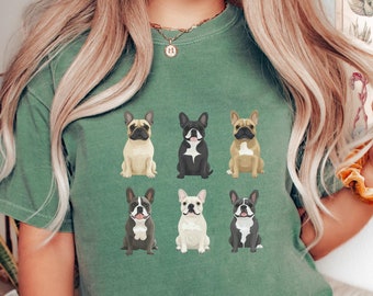 May include: A green t-shirt with a graphic of six French Bulldogs in different poses. The dogs are brown, black, and white.