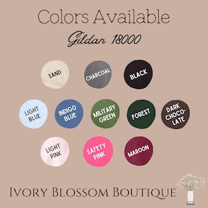 May include: Colour chart for Gildan 18000 t-shirts.  Colours include: Sand, Charcoal, Black, Light Blue, Indigo Blue, Military Green, Forest, Dark Chocolate, Light Pink, Safety Pink, and Maroon.