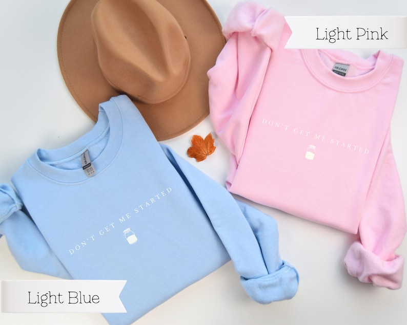 May include: Two sweatshirts, one light blue and one light pink, with the text "Don't get me started" and a small milk carton graphic printed on the front.