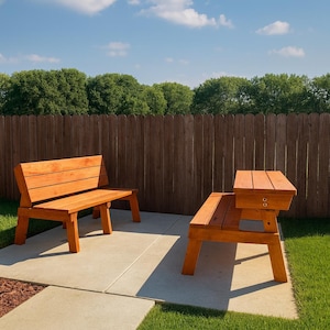 May include: Two wooden benches, one with a backrest and the other with a side table, are set on a concrete patio. The benches are made of light brown wood and are positioned in front of a wooden fence and green grass.