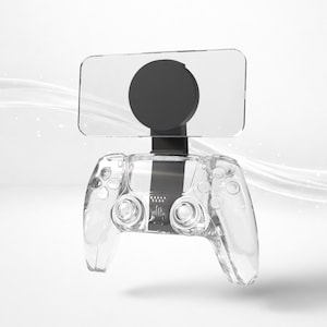 Könnte beinhalten: Ein transparentes Gaming-Controller mit einem schwarzen kreisförmigen Aufsatz und einem rechteckigen Bildschirm. Der Controller hat ein schlankes Design mit sichtbaren internen Komponenten. Der Hintergrund ist weiß mit subtilen, fließenden Linien.