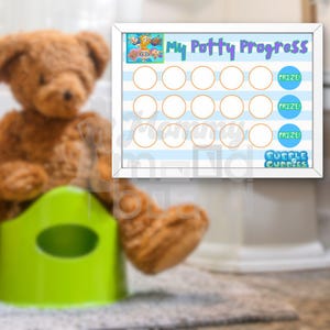 May include: A white framed chart with blue and white stripes and orange circles. The chart is titled "My Potty Progress" and features a cartoon image of characters from the show "Bubble Guppies". The chart has 12 circles for tracking potty training progress.  The chart also has the words "Prize!" and "Bubble Guppies" printed on it.