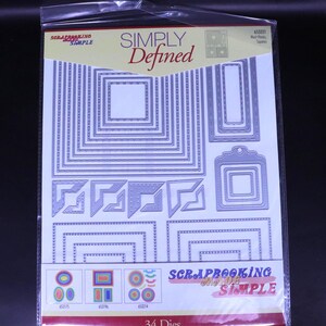 May include: A pack of Simply Defined metal dies for scrapbooking. The dies are in various shapes, including squares, rectangles, and decorative corner pieces. The package also includes the text "Scrapbooking Made Simple" and "34 Dies".