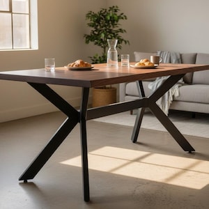 May include: A rectangular dining table with a dark wood top and black metal legs. The table is set with plates of food, glasses, and a water carafe. The table is approximately 72 inches long.