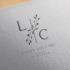 Pode incluir: Um convite de casamento com um design floral simples e as iniciais "L" e "C" para Laura e Carl. A data é 10.10.2030.