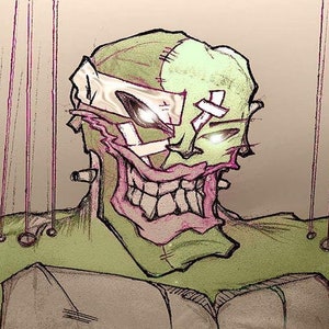 May include: A green and white stitched monster puppet with a wide, toothy grin. The puppet is attached to strings and has a stitched-on bandage on its forehead.