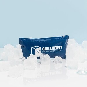 May include: A blue ice pack with the text "Chillnervy put your anxiety on ice" printed on it. The ice pack is surrounded by ice cubes.