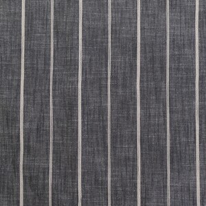 May include: Close-up of a fabric with a dark gray background and vertical white stripes. The fabric has a textured appearance, with the stripes evenly spaced across the surface. The stripes are thin and create a simple, classic pattern.