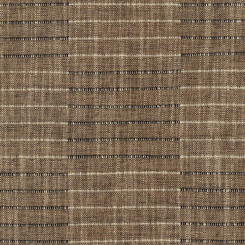 May include: Close-up of a woven fabric with a brown and beige color scheme. The fabric has a textured appearance with horizontal stripes of varying widths and colors, creating a grid-like pattern. The stripes alternate between brown, beige, and black.