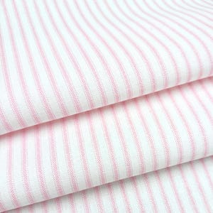 a close-up view of a fabric with pink and white striped patterns.