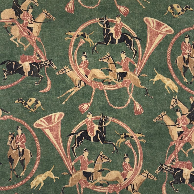 May include: Green fabric with a repeating pattern of riders on horseback, hunting dogs, and French horns. The riders wear red coats and black riding hats. The horns and decorative elements are in shades of red and beige.