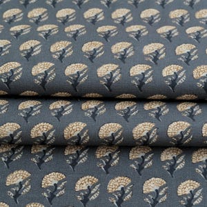 May include: A dark gray fabric featuring a repeating pattern of small, stylized flowers. Each flower has a textured, light tan circular head and a dark gray stem with leaves, arranged in uniform rows across the woven textile surface.