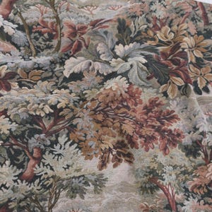 Scenic foliage tapestry upholstery fabric in warm Woodrose tones draped across surface, heavyweight jacquard textile with verdure design, antique style woven fabric by the yard for drapery, slipcovers, vintage furniture upholstery, decorative pillows, and wall hangings.