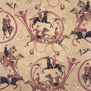 May include: Tan fabric with a repeating pattern of riders on horseback, hunting horns, and hounds. The riders wear red jackets and black riding boots. The horns and decorative elements are in a burgundy color.