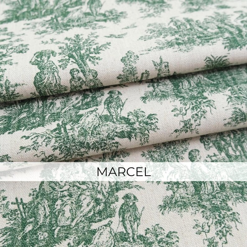 May include: A folded piece of off-white fabric featuring a repeating dark green toile pattern of figures in a landscape with trees and foliage. The word MARCEL is printed in a simple black sans-serif font across the center of the image.