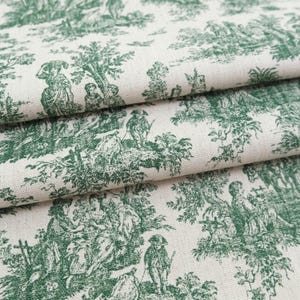 May include: A cream-colored fabric featuring a repeating dark green toile print. The pattern depicts detailed pastoral scenes with figures, trees, and foliage arranged in a classic narrative style across the textured woven textile surface.